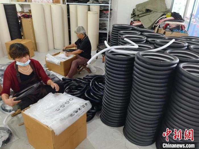 圖為村民在汽車(chē)飾品企業(yè)生產(chǎn)車(chē)間中工作?！巫雍?攝