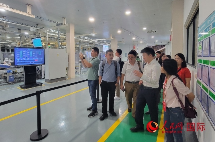 廣汽埃安工作人員向外媒記者進(jìn)行介紹。人民網(wǎng) 寧玉瑛攝