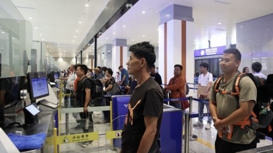 6月13日，乘坐中老鐵路國際旅客列車的旅客在磨憨邊檢大廳排隊(duì)候檢。李揚(yáng) 攝