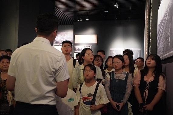 （講解員為記者團(tuán)同學(xué)們講述歷史。北京舞蹈學(xué)院 全峻汐攝