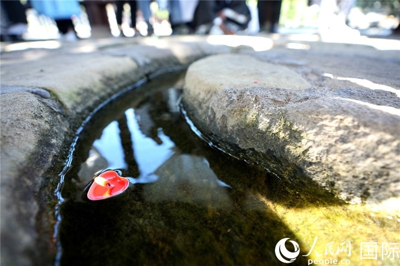 圖為水渠里流過的“桃心”蠟燭。人民網(wǎng) 盧鵬宇攝