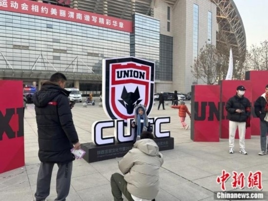 球迷們與隊(duì)徽合影。記者 卞立群 攝