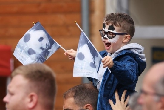  2023年7月26日，在法國圣艾尼昂市博瓦勒野生動物園外，一名兒童等待送別熊貓“圓夢”。新華社記者 高靜 攝
