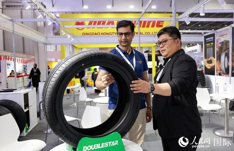 工作人員向客戶展示雙星電動(dòng)汽車輪胎。和傳統(tǒng)汽車輪胎相比，電動(dòng)汽車輪胎具有更高承載能力、更加靜音舒適、更好極速抓地、更低滾動(dòng)阻力等特點(diǎn)。人民網(wǎng)記者 管克江攝