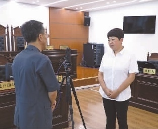 圖為全國人大代表玉明姬（右）詳細了解環(huán)境資源審判工作情況。劉思妤 攝